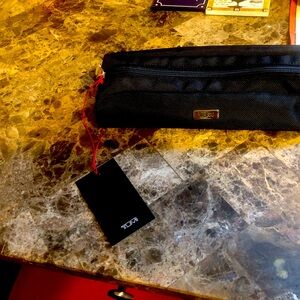 A Tumi Cord/ charger pouch: new and never used with tags on